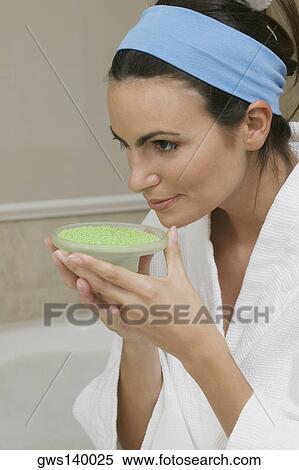 Close-up of a young woman smelling a dish of bath crystals View Large Photo Image Stock Photography - Close-up of a young woman smelling a dish of bath crystals. Fotosearch
