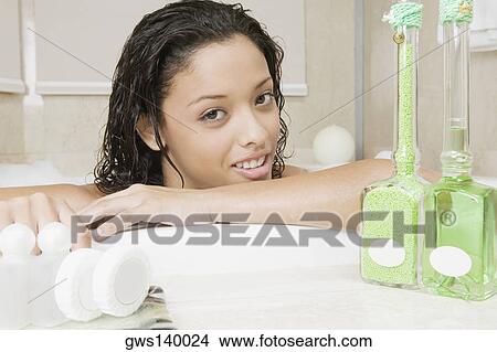 Picture - Portrait of a teenage girl having a bath. Fotosearch