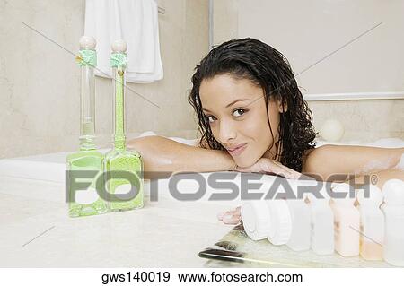 Stock Photo - Portrait of a teenage girl having a bath. Fotosearch