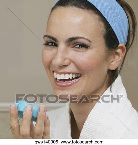 Portrait of a young woman holding a bar of soap View Large Photo Image Stock Photography - Portrait of a young woman holding a bar of soap. Fotosearch