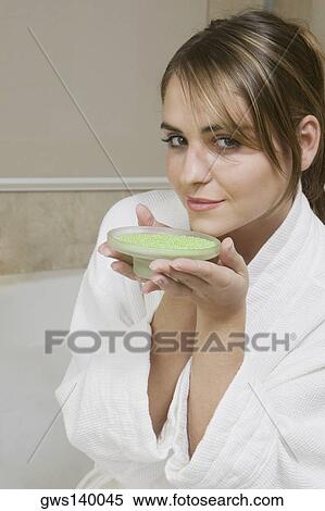 Portrait of a young woman smelling a dish of bath crystals View Large Photo Image Stock Photography - Portrait of a young woman smelling a dish of bath crystals. Fotosearch