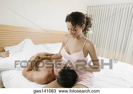 Close-up of a mid adult man lying on a teenage girl's lap and smiling View Large Photo Image Stock Image - Close-up of a mid adult man lying on a teenage girl's lap and smiling. Fotosearch