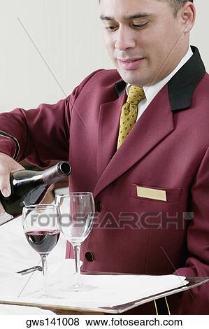 Close-up of a waiter pouring red wine into wineglasses View Large Photo Image Stock Photo - Close-up of a waiter pouring red wine into wineglasses. Fotosearch