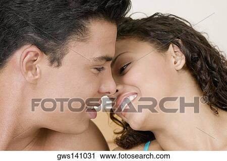 Close-up of a young man and a teenage girl facing each other View Large Photo Image Stock Image - Close-up of a young man and a teenage girl facing each other. Fotosearch