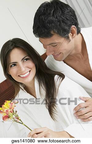 Close-up of a young woman and a mid adult man smiling View Large Photo Image Stock Image - Close-up of a young woman and a mid adult man smiling. Fotosearch