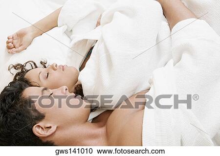 High angle view of a young man and a teenage girl sleeping View Large Photo Image Stock Image - High angle view of a young man and a teenage girl sleeping. Fotosearch