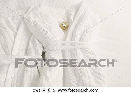 Stock Photography - High angle view of two bathrobes on the bed. Fotosearch