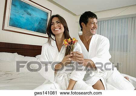 Low angle view of a mid adult man giving flowers to a young woman View Large Photo Image Stock Image - Low angle view of a mid adult man giving flowers to a young woman. Fotosearch