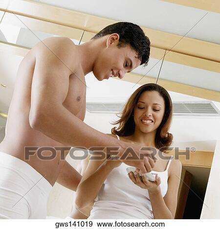 Low angle view of a young man and a teenage girl looking at a saucer View Large Photo Image Stock Photo - Low angle view of a young man and a teenage girl looking at a saucer. Fotosearch