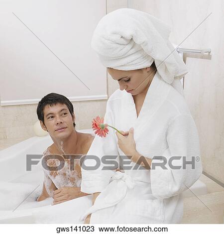 Mid adult man looking at a young woman sitting near him in the bathtub View Large Photo Image Stock Image - Mid adult man looking at a young woman sitting near him in the bathtub . Fotosearch