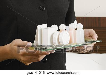 Mid section view of a woman holding a serving tray View Large Photo Image Stock Photograph - Mid section view of a woman holding a serving tray. Fotosearch
