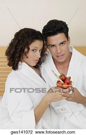 Portrait of a young man and a teenage girl holding a glass of strawberries View Large Photo Image Stock Image - Portrait of a young man and a teenage girl holding a glass of strawberries. Fotosearch