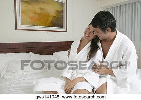 Young woman leaning on a mid adult man on the bed View Large Photo Image Stock Photography - Young woman leaning on a mid adult man on the bed. Fotosearch