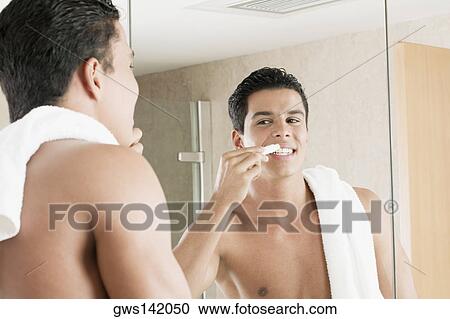 Close-up of a young man applying lip balm View Large Photo Image Stock Image - Close-up of a young man applying lip balm. Fotosearch