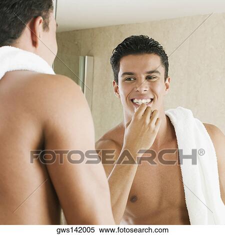 Close-up of a young man applying lip balm View Large Photo Image Stock Photography - Close-up of a young man applying lip balm. Fotosearch