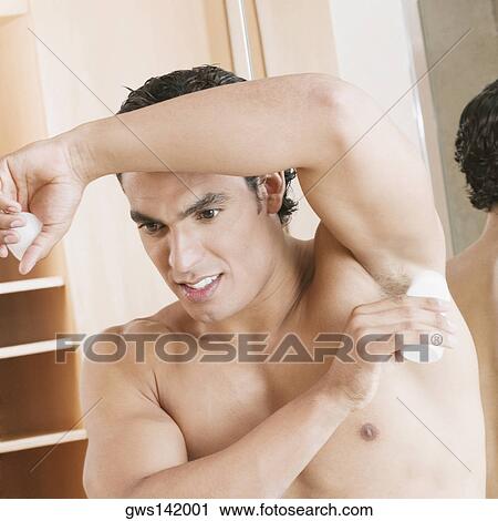 Close-up of a young man applying deodorant under his arm View Large Photo Image Stock Image - Close-up of a young man applying deodorant under his arm. Fotosearch