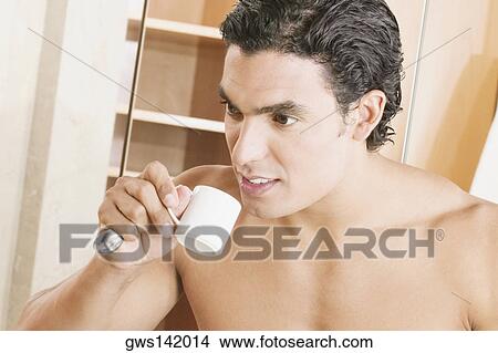 Close-up of a young man drinking a cup of tea View Large Photo Image Picture - Close-up of a young man drinking a cup of tea. Fotosearch