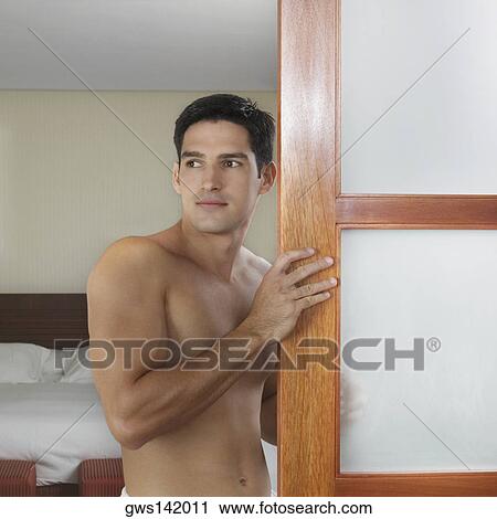 Side profile of a young man standing near a door View Large Photo Image Stock Image - Side profile of a young man standing near a door. Fotosearch