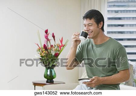 Mid adult man drinking a cup of tea View Large Photo Image Stock Image - Mid adult man drinking a cup of tea. Fotosearch