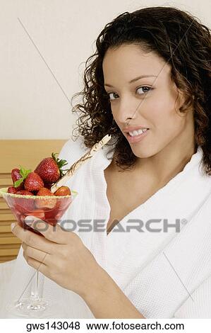 Portrait of a teenage girl holding a glass of strawberries View Large Photo Image Stock Photo - Portrait of a teenage girl holding a glass of strawberries. Fotosearch