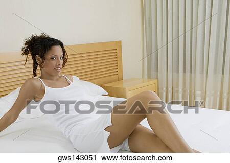 Portrait of a teenage girl reclining on the bed View Large Photo Image Stock Image - Portrait of a teenage girl reclining on the bed. Fotosearch