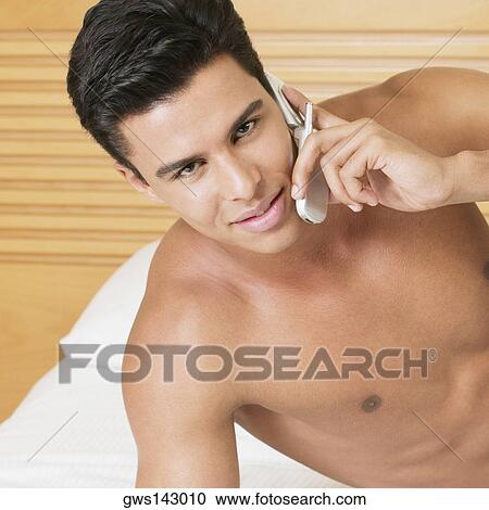 Portrait of a young man talking on a mobile phone View Large Photo Image Stock Image - Portrait of a young man talking on a mobile phone. Fotosearch