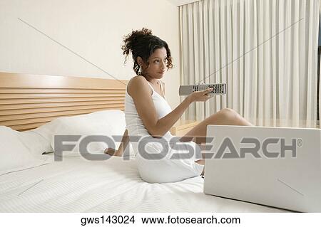 Side profile of a teenage girl using a remote control View Large Photo Image Picture - Side profile of a teenage girl using a remote control. Fotosearch