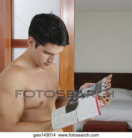 Side profile of a young man reading a magazine View Large Photo Image Picture - Side profile of a young man reading a magazine. Fotosearch