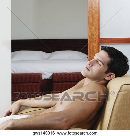 Side profile of a young man sleeping in an armchair View Large Photo Image Stock Photograph - Side profile of a young man sleeping in an armchair. Fotosearch