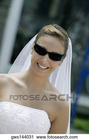 Stock Image - Close-up of a bride wearing sunglasses. Fotosearch