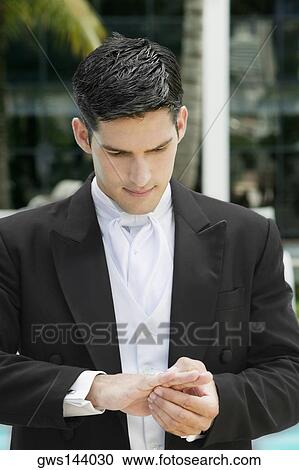 Close-up of a groom adjusting his wedding ring View Large Photo Image Stock Image - Close-up of a groom adjusting his wedding ring. Fotosearch