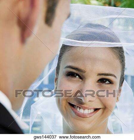 Close-up of a groom lifting his bride's veil View Large Photo Image Stock Photo - Close-up of a groom lifting his bride's veil. Fotosearch