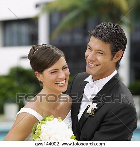 Close-up of a newlywed couple smiling View Large Photo Image Stock Image - Close-up of a newlywed couple smiling. Fotosearch