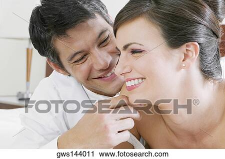 Close-up of a newlywed couple smiling View Large Photo Image Stock Image - Close-up of a newlywed couple smiling. Fotosearch