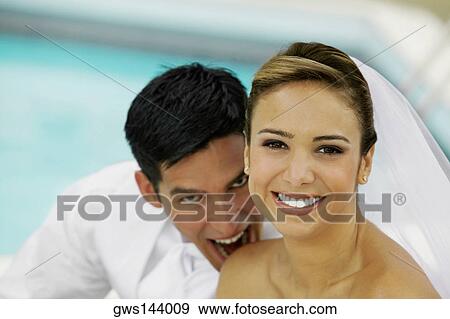 Close-up of a newlywed couple smiling View Large Photo Image Stock Photo - Close-up of a newlywed couple smiling. Fotosearch