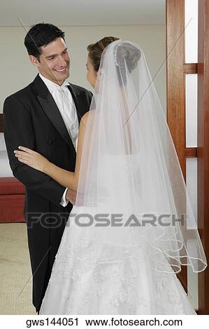 Newlywed couple looking at each other and smiling View Large Photo Image Stock Image - Newlywed couple looking at each other and smiling. Fotosearch