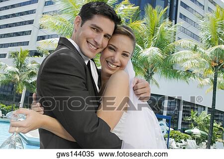 Portrait of a newlywed couple embracing each other View Large Photo Image Stock Photography - Portrait of a newlywed couple embracing each other. Fotosearch