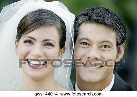 Portrait of a newlywed couple smiling View Large Photo Image Picture - Portrait of a newlywed couple smiling. Fotosearch