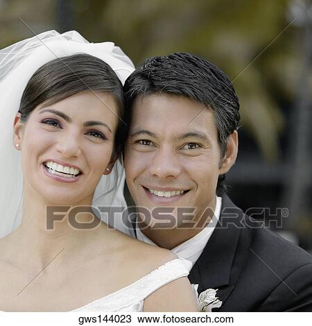 Stock Image - Portrait of a newlywed couple smiling. Fotosearch