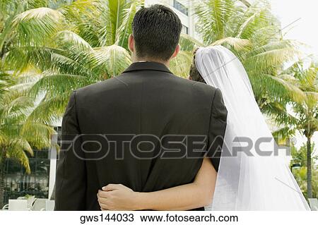 Rear view of a newlywed couple View Large Photo Image Stock Image - Rear view of a newlywed couple. Fotosearch