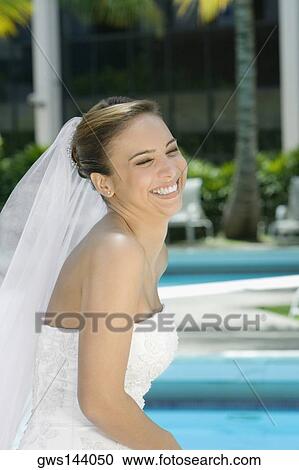 Stock Image - Side profile of a bride smiling. Fotosearch