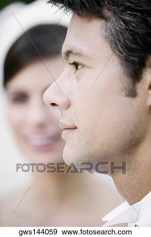 Stock Photo - Side profile of a groom looking serious. Fotosearch