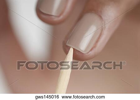 Close-up of a woman's hand giving herself a manicure View Large Photo Image Stock Photograph - Close-up of a woman's hand giving herself a manicure. Fotosearch