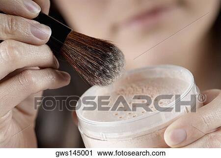 Close-up of a woman's hand holding a pot of face powder and a make-up brush View Large Photo Image Stock Image - Close-up of a woman's hand holding a pot of face powder and a make-up brush. Fotosearch