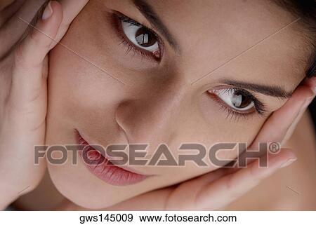 Close-up of a young woman thinking View Large Photo Image Stock Photo - Close-up of a young woman thinking. Fotosearch