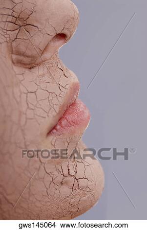 Picture - Close-up of a young woman's face with a facial mask. Fotosearch