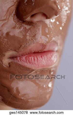 Stock Photo - Close-up of a young woman's face with a facial mask. Fotosearch