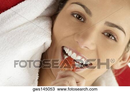 Portrait of a young woman eating a strawberry View Large Photo Image Stock Image - Portrait of a young woman eating a strawberry. Fotosearch