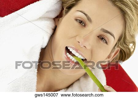 Portrait of a young woman eating an asparagus View Large Photo Image Stock Photo - Portrait of a young woman eating an asparagus. Fotosearch