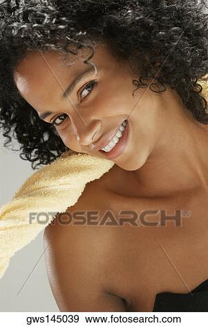 Portrait of a young woman smiling View Large Photo Image Stock Photo - Portrait of a young woman smiling. Fotosearch